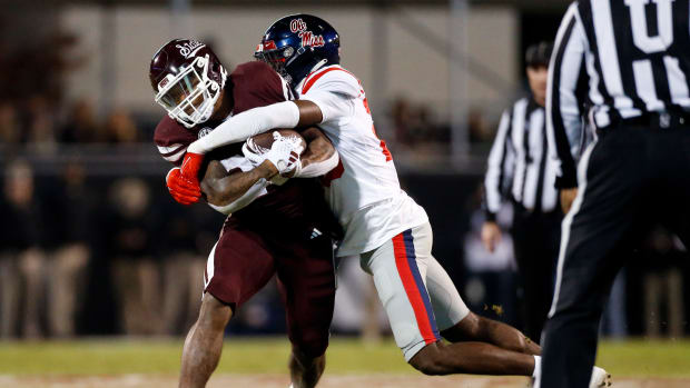 Nov 23, 2023; Starkville, Mississippi, USA; Mississippi State Bulldogs running back Jeffery Pittman (25) runs the ball as Mississippi Rebels linebacker Khari Coleman (23) makes the tackle during the first half at Davis Wade Stadium at Scott Field. Mandatory Credit: Petre Thomas-USA TODAY Sports